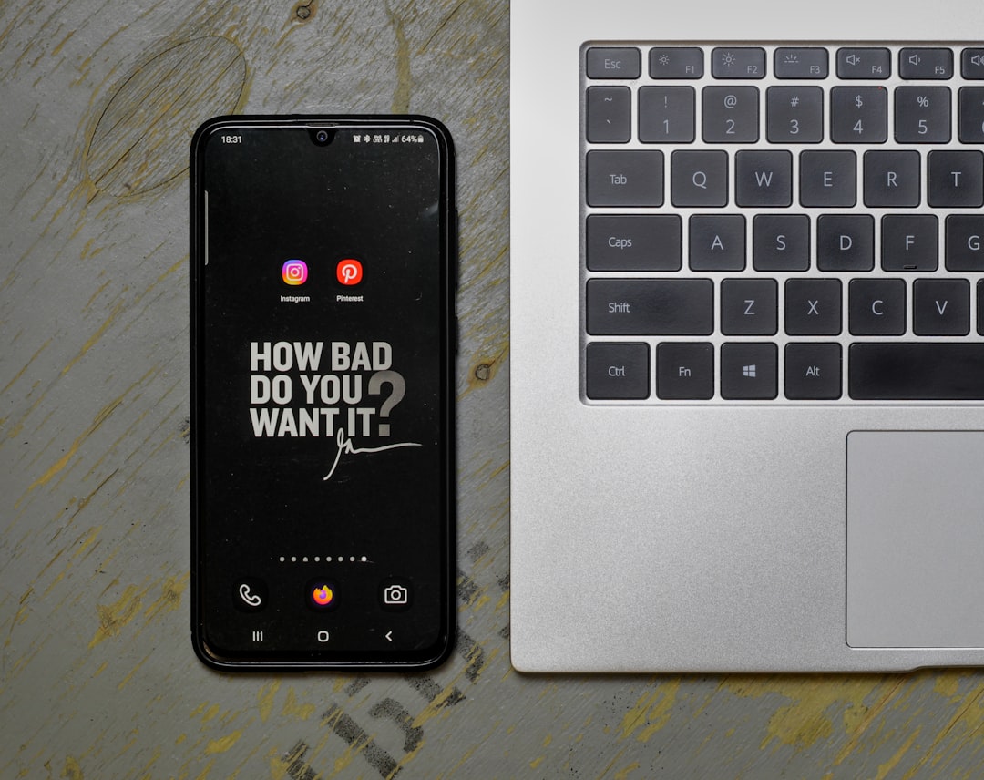 a cell phone sitting next to a laptop computer