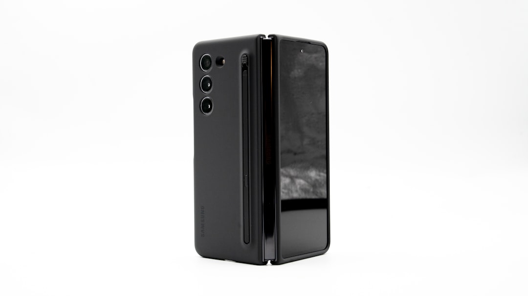 a close up of a cell phone on a white surface